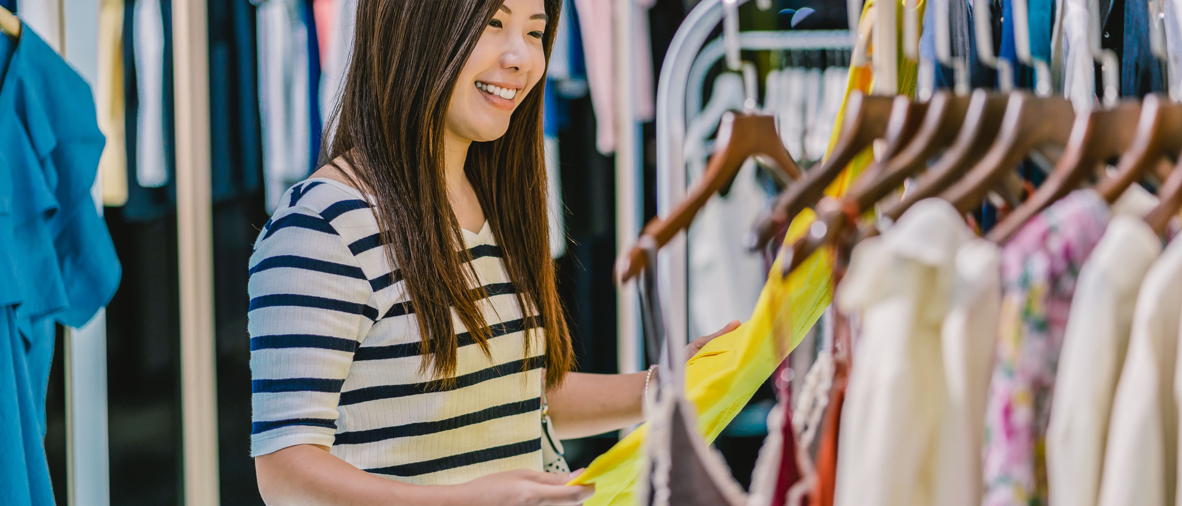 A young woman shopping different clothes.