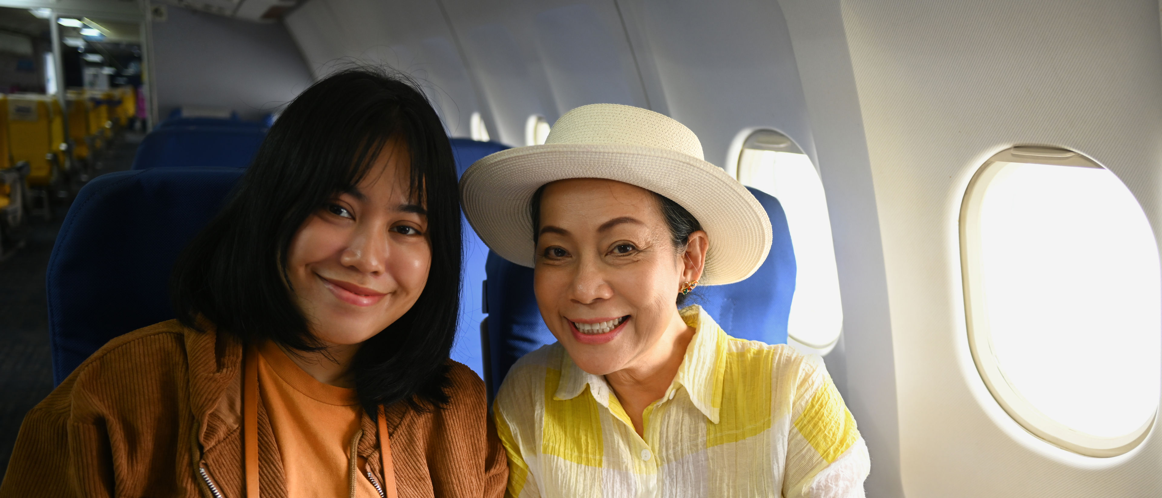 Two women travelling in a flight.